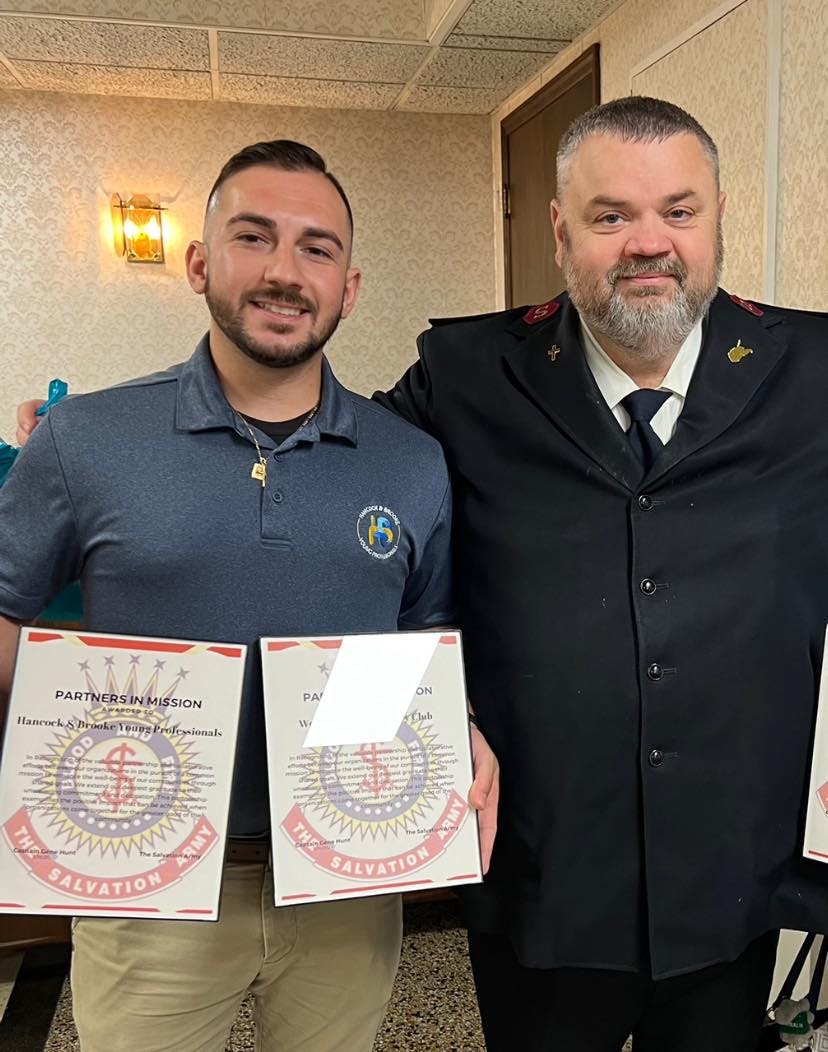 brandon accepting an award from gene from the salvation army